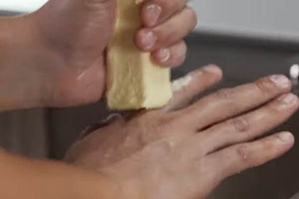 Removing-caulk-from-hands-using-butter